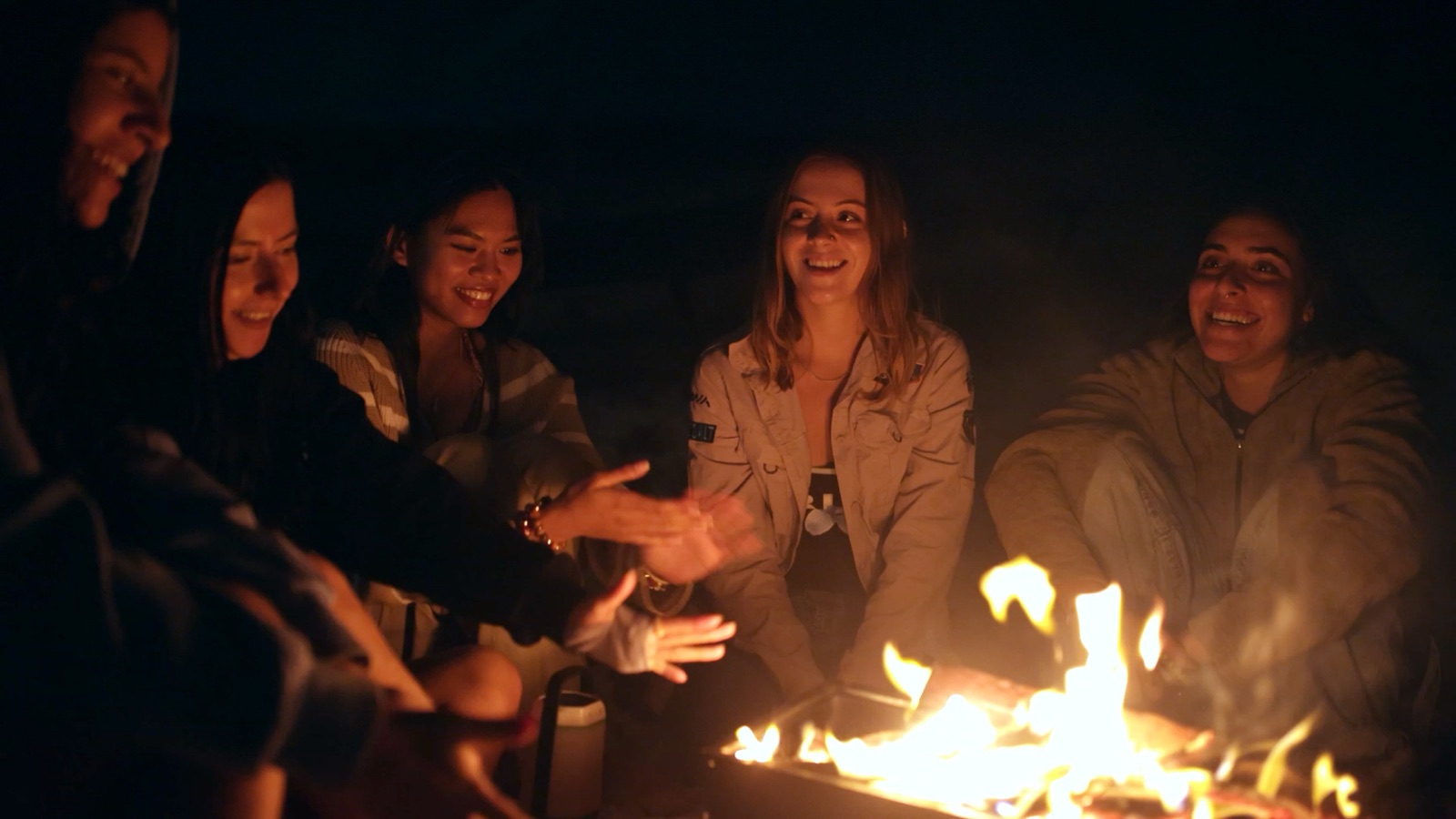 Friends sitting around the island campfire