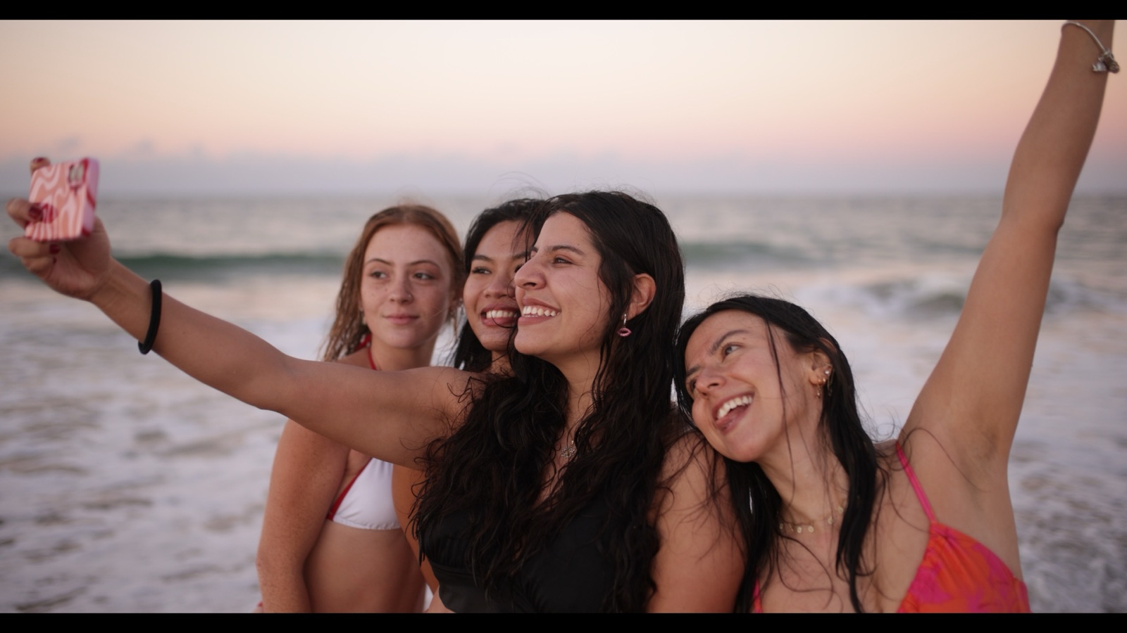 Friends laughing together in the ocean at Moreton Island
