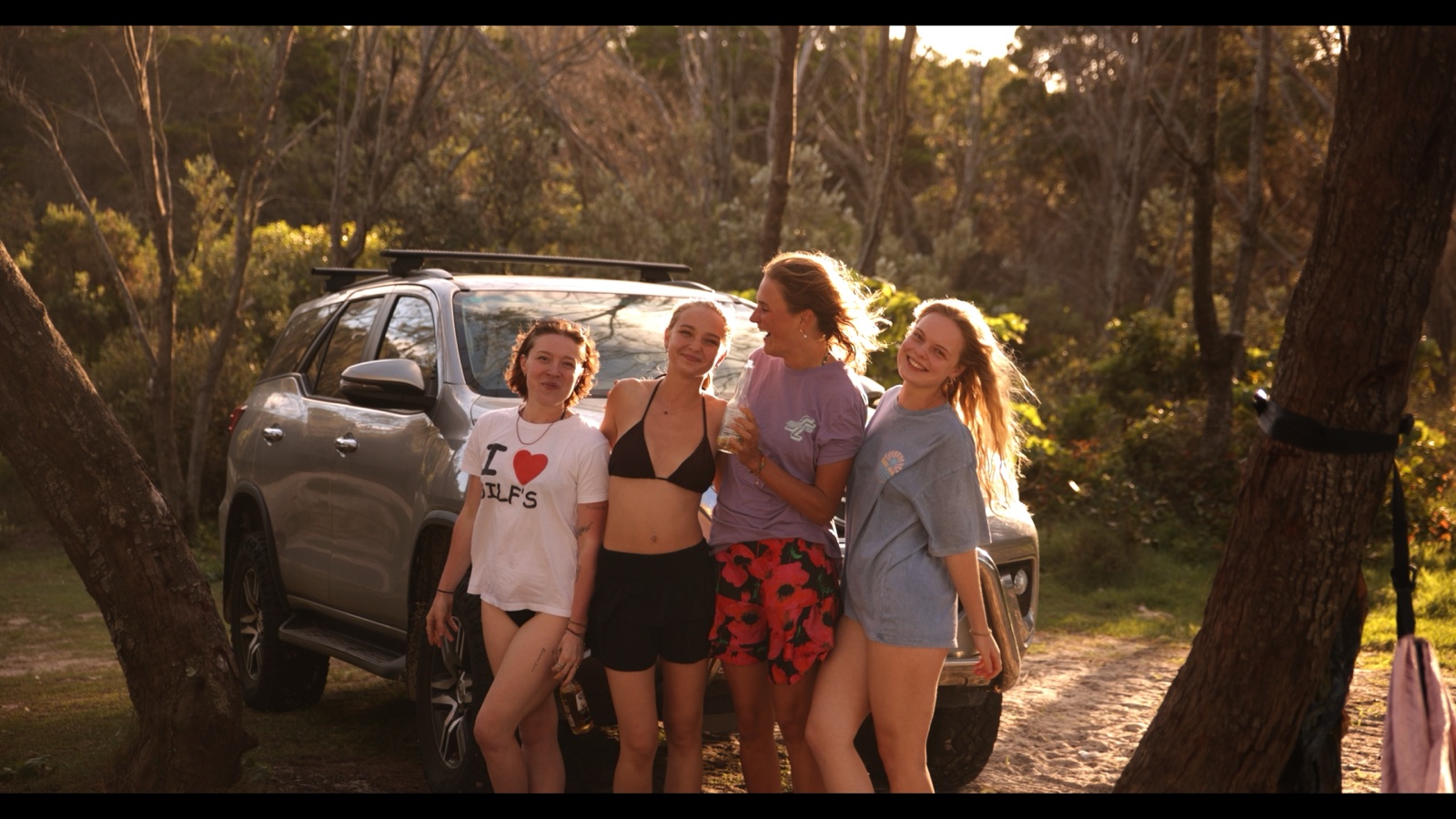 Friends gathered beside their four-wheel-drive at the island campsite